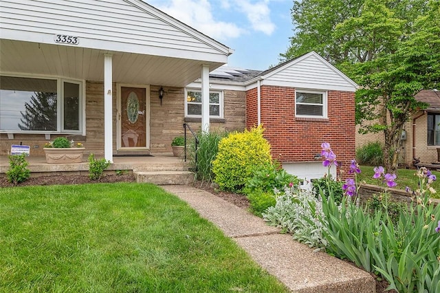 3353 Mcroberts Rd, Castle Shannon, PA 15234 - property entrance featuring roof mounted solar panels, a lawn, a porch, and brick siding