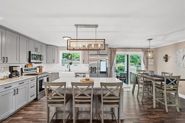 6003 Kingston Dr, Hopewell Twp Bea, PA 15001 - kitchen with appliances with stainless steel finishes, gray cabinetry, a sink, dark wood-style flooring, and plenty of natural light