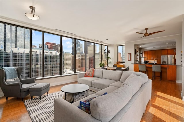 151 Fort Pitt Blvd Unit 1703, Downtown Pgh, PA 15222 - living area with light wood finished floors, a view of city, a ceiling fan, and baseboards