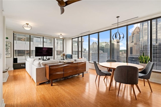 151 Fort Pitt Blvd Unit 1703, Downtown Pgh, PA 15222 - living area featuring light wood-type flooring, plenty of natural light, ceiling fan, and a chandelier