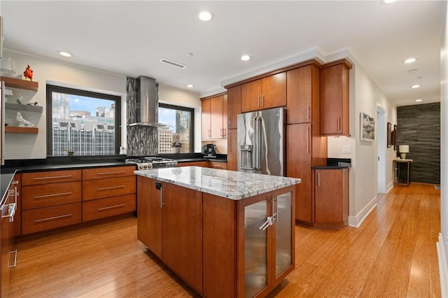 151 Fort Pitt Blvd Unit 1703, Downtown Pgh, PA 15222 - kitchen featuring ventilation hood, brown cabinetry, light wood finished floors, dark stone counters, and glass insert cabinets