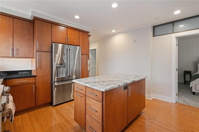 151 Fort Pitt Blvd Unit 1703, Downtown Pgh, PA 15222 - kitchen featuring high end fridge, light wood-style floors, stove, brown cabinets, and a kitchen island