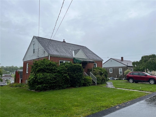 256 Vermont St, Hempfield Twp Wml, PA 15601 - bungalow featuring brick siding, a front yard, and a shingled roof