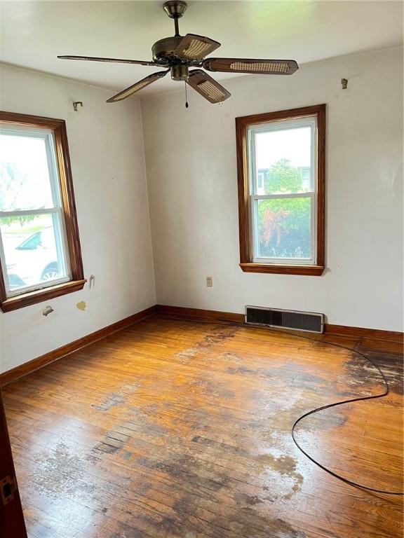 256 Vermont St, Hempfield Twp Wml, PA 15601 - empty room with healthy amount of natural light, hardwood / wood-style flooring, ceiling fan, and baseboards