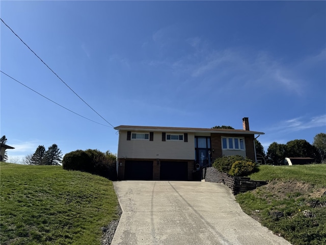209 Pawnee St, Rostraver, PA 15012 - view of front facade featuring an attached garage, a chimney, driveway, and a front yard