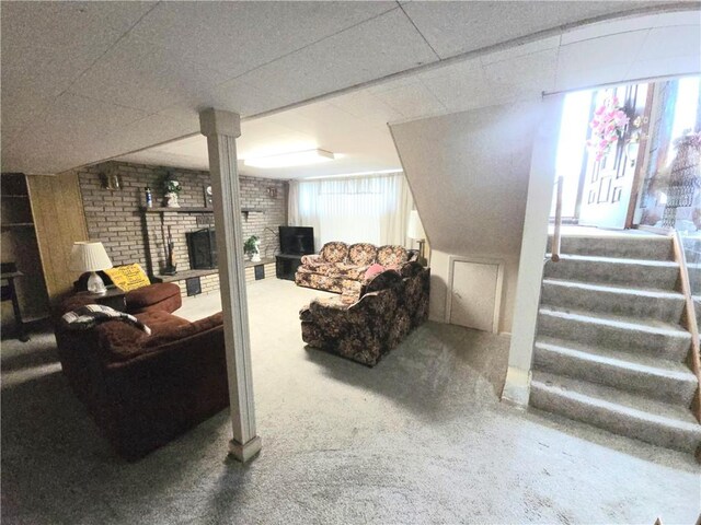 209 Pawnee St, Rostraver, PA 15012 - below grade area featuring a brick fireplace, carpet, stairs, and brick wall