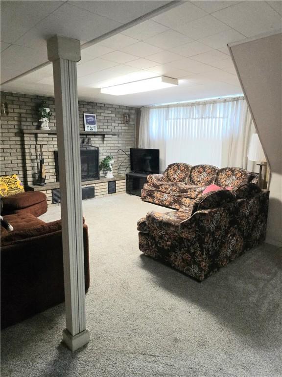 209 Pawnee St, Rostraver, PA 15012 - carpeted living area featuring a brick fireplace