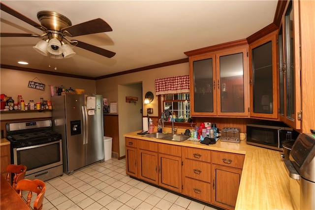 1019 Boulder St, California, PA 15419 - kitchen featuring stainless steel appliances, light countertops, a sink, brown cabinetry, and ceiling fan