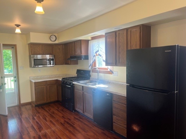 1320 High, Jefferson Hills, PA 15025 - kitchen featuring black appliances, a sink, under cabinet range hood, light countertops, and dark wood-type flooring