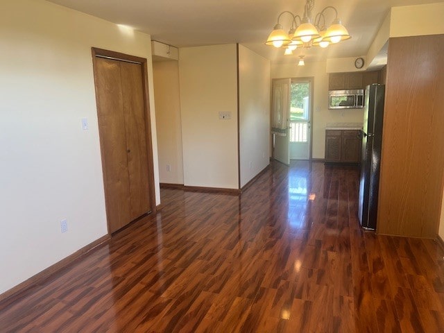 1320 High, Jefferson Hills, PA 15025 - empty room featuring dark wood finished floors, a chandelier, and baseboards