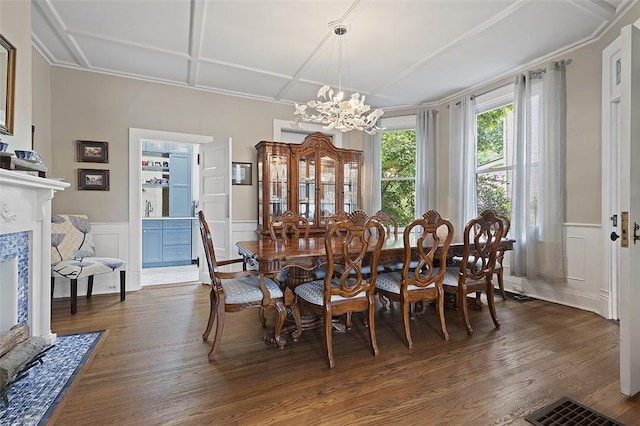 194 Beaver St, Beaver, PA 15009 - dining room with a chandelier, dark wood-type flooring, coffered ceiling, a decorative wall, and a wainscoted wall