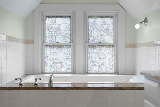 194 Beaver St, Beaver, PA 15009 - bathroom featuring a garden tub, tile walls, and lofted ceiling