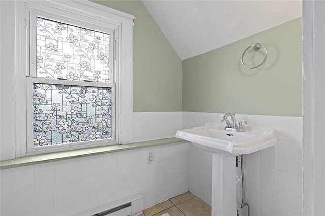 194 Beaver St, Beaver, PA 15009 - bathroom with lofted ceiling, tile patterned flooring, tile walls, and wainscoting
