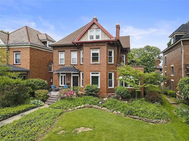 194 Beaver St, Beaver, PA 15009 - view of front of house featuring a chimney, a front yard, and brick siding