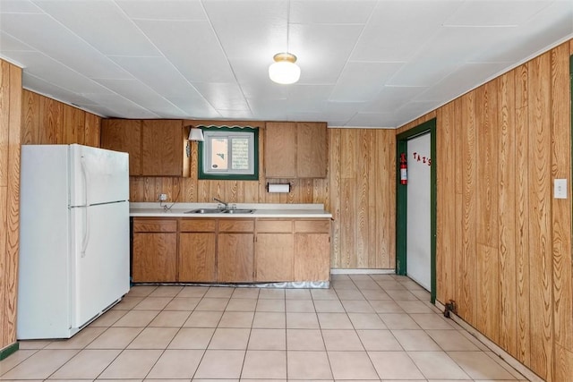 1458 Isoline, Sheraden, PA 15204 - kitchen featuring freestanding refrigerator, a sink, light countertops, wood walls, and brown cabinets