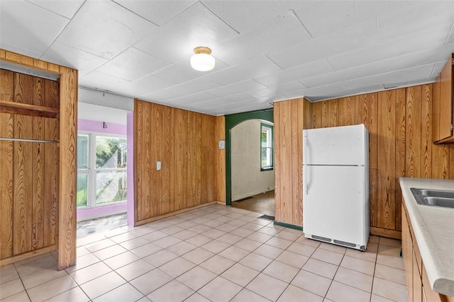 1458 Isoline, Sheraden, PA 15204 - kitchen with freestanding refrigerator, wood walls, light countertops, healthy amount of natural light, and brown cabinetry