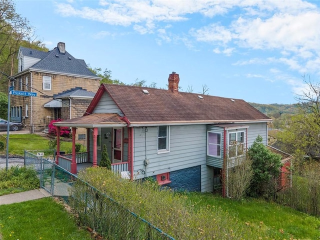 1458 Isoline, Sheraden, PA 15204 - view of front of house featuring a chimney, covered porch, a shingled roof, and a gate