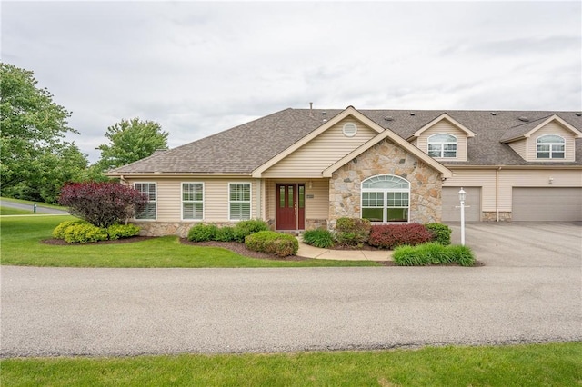 6055 Triple Crown Cir, Hempfield Twp Wml, PA 15601 - view of front facade featuring stone siding, a garage, a shingled roof, and driveway