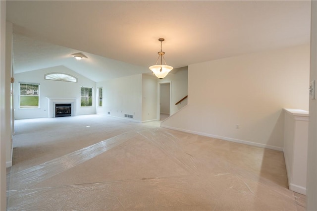 6055 Triple Crown Cir, Hempfield Twp Wml, PA 15601 - unfurnished living room with light carpet, lofted ceiling, a fireplace, and baseboards