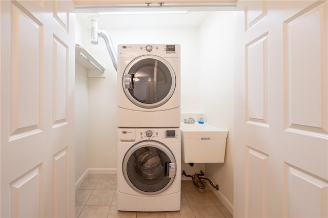 6055 Triple Crown Cir, Hempfield Twp Wml, PA 15601 - washroom with stacked washer and clothes dryer, light tile patterned floors, and baseboards