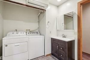 929 Al Smith Dr, Kennedy Twp, PA 15136 - laundry area featuring separate washer and dryer, a wall unit AC, and cabinet space