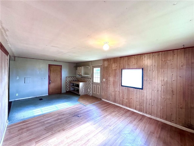 3406 New Castle, West Middlesex Boro, PA 16159 - unfurnished living room featuring wood finished floors, baseboards, and wood walls