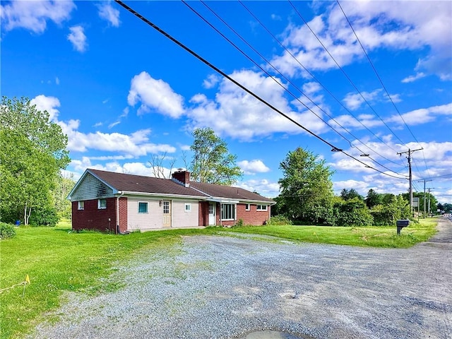 3406 New Castle, West Middlesex Boro, PA 16159 - view of front facade with brick siding, a front lawn, a chimney, and driveway
