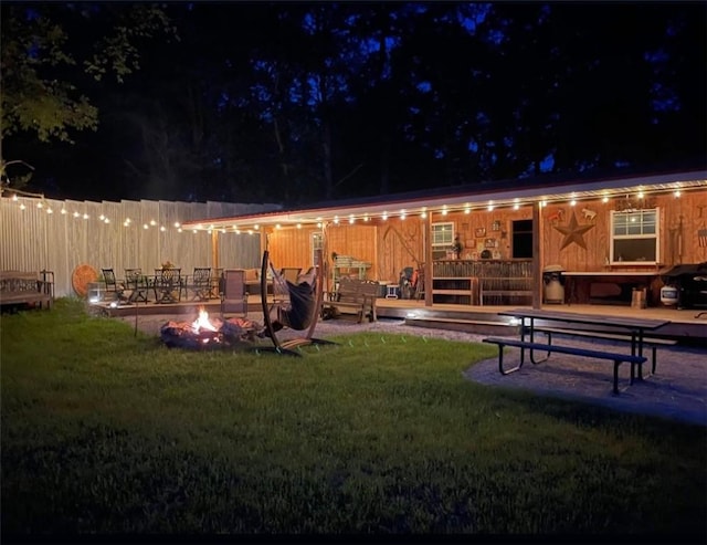 1060 Sugar Run Rd, Nottingham, PA 15367 - yard at twilight with a fire pit, a lawn, and a wooden deck