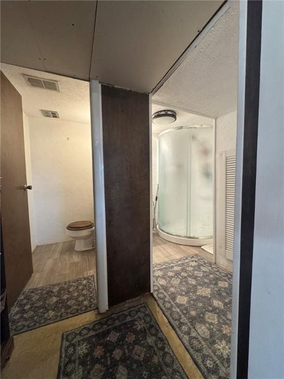 1060 Sugar Run Rd, Nottingham, PA 15367 - bathroom featuring toilet, a stall shower, and wood finished floors