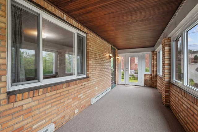 191 Clearview, West View, PA 15229 - unfurnished sunroom featuring brick wall, a baseboard heating unit, wood ceiling, and carpet