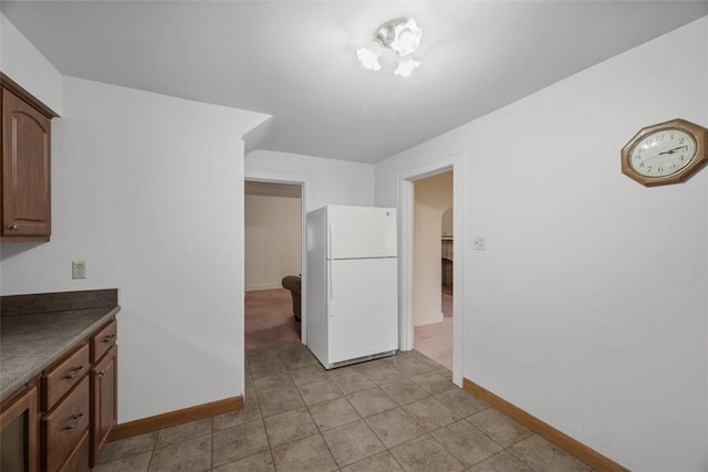 191 Clearview, West View, PA 15229 - kitchen with freestanding refrigerator, baseboards, dark countertops, light tile patterned floors, and arched walkways