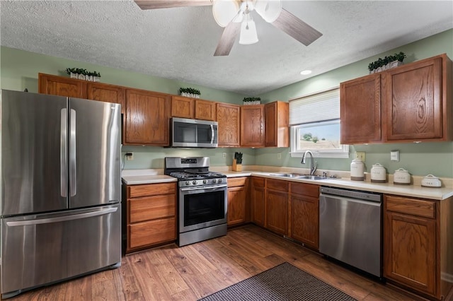 763 Chapel Rd, Center Twp Bea, PA 15001 - kitchen featuring stainless steel appliances, a sink, a textured ceiling, dark wood-style flooring, and light countertops