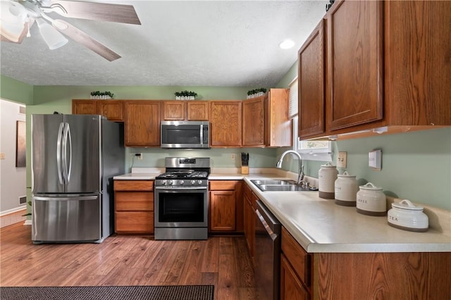 763 Chapel Rd, Center Twp Bea, PA 15001 - kitchen featuring appliances with stainless steel finishes, a sink, brown cabinets, light countertops, and wood finished floors