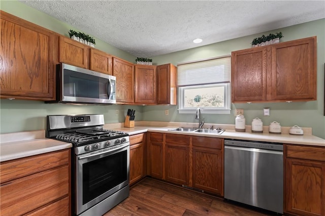 763 Chapel Rd, Center Twp Bea, PA 15001 - kitchen featuring appliances with stainless steel finishes, a sink, a textured ceiling, dark wood finished floors, and brown cabinetry