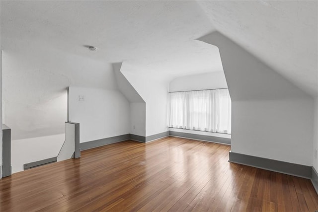 2938 Voelkel Ave, Dormont, PA 15216 - additional living space featuring lofted ceiling, hardwood / wood-style flooring, baseboards, and a textured ceiling