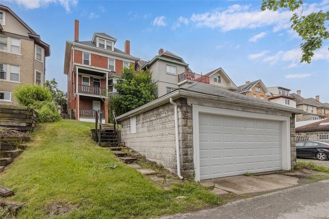 2938 Voelkel Ave, Dormont, PA 15216 - view of property exterior featuring stairs, a garage, a lawn, stone siding, and a residential view