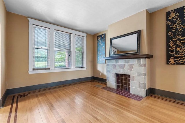 2938 Voelkel Ave, Dormont, PA 15216 - unfurnished living room featuring wood finished floors, a fireplace with flush hearth, and baseboards