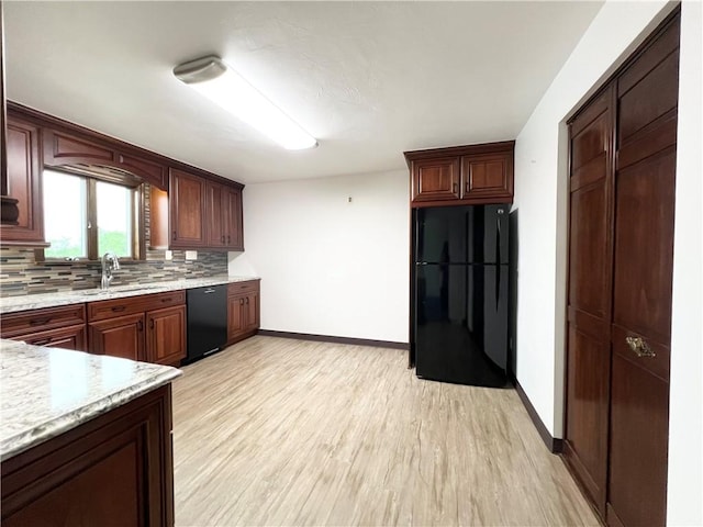 4130 James Dr, Lower Burrell, PA 15068 - kitchen with black appliances, baseboards, tasteful backsplash, a sink, and light wood-style floors
