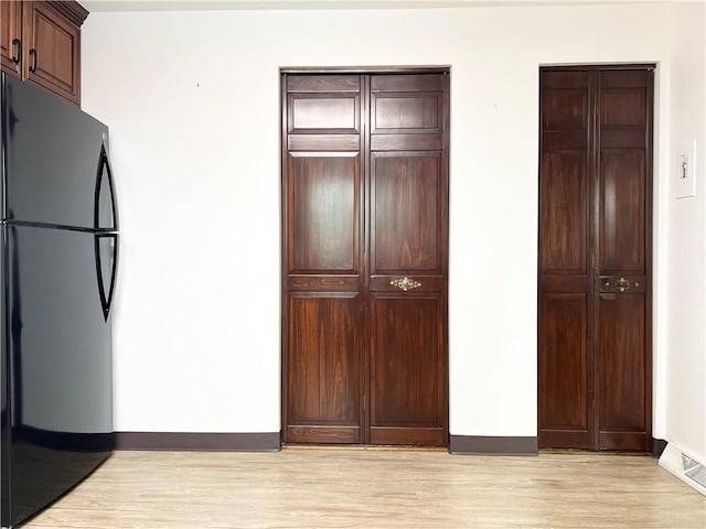 4130 James Dr, Lower Burrell, PA 15068 - kitchen with freestanding refrigerator, baseboards, and light wood-style floors