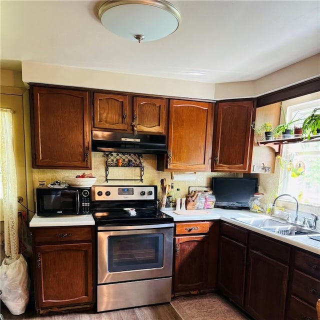 389 Beech Rd, Plum Boro, PA 15239 - kitchen featuring under cabinet range hood, electric stove, black microwave, a sink, and light countertops