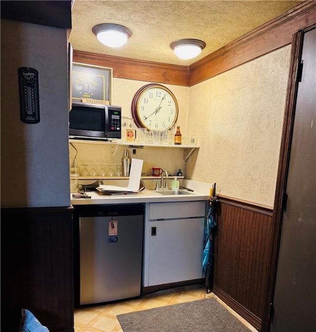 389 Beech Rd, Plum Boro, PA 15239 - indoor wet bar with stainless steel microwave, dishwasher, a textured ceiling, a wainscoted wall, and ornamental molding