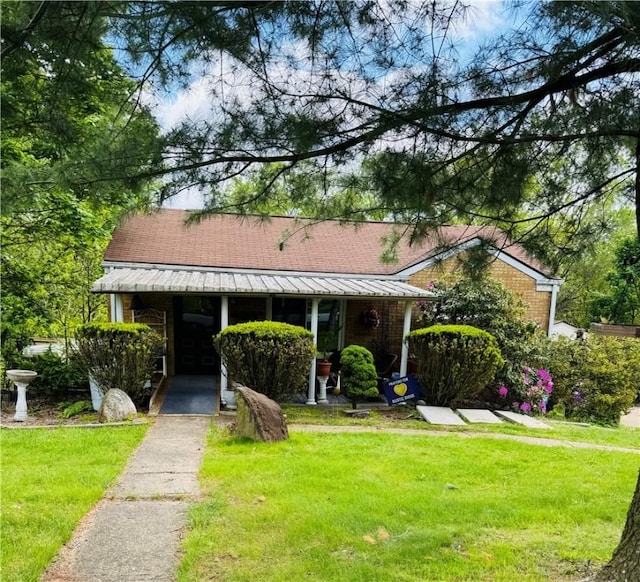 389 Beech Rd, Plum Boro, PA 15239 - bungalow-style home featuring a front lawn, covered porch, metal roof, and brick siding