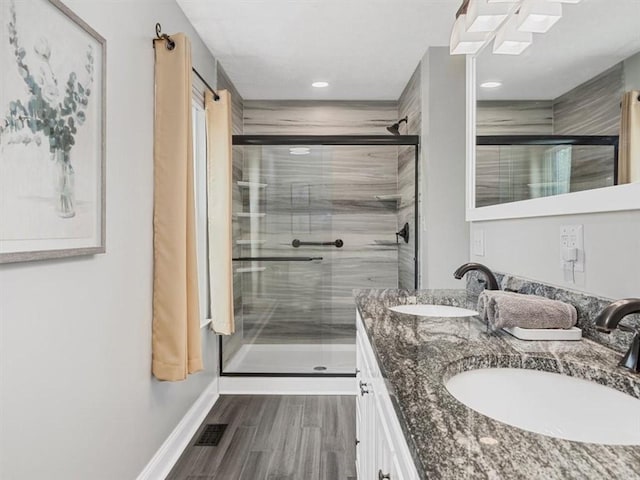 13 Westchester Ct, Robinson Twp Nwa, PA 15136 - bathroom with double vanity, a shower stall, wood finished floors, baseboards, and recessed lighting
