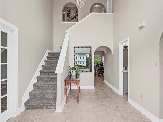 13 Westchester Ct, Robinson Twp Nwa, PA 15136 - entrance foyer with arched walkways, stairs, baseboards, and a high ceiling