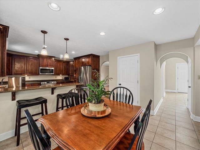 13 Westchester Ct, Robinson Twp Nwa, PA 15136 - dining room with arched walkways, light tile patterned flooring, recessed lighting, and baseboards