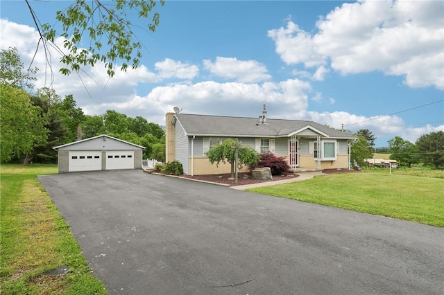 1509 Edmon Rd, Kiskiminetas Twp, PA 15618 - view of front of property with a detached garage, an outdoor structure, a front yard, and a chimney