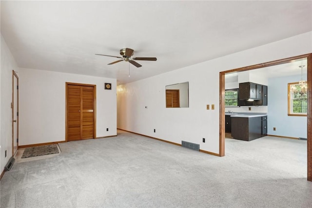 1509 Edmon Rd, Kiskiminetas Twp, PA 15618 - unfurnished living room with a ceiling fan, light colored carpet, and baseboards