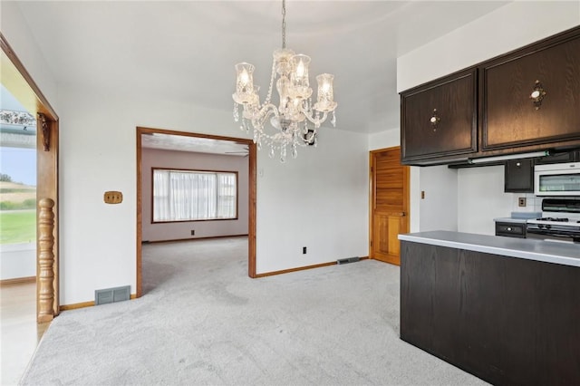 1509 Edmon Rd, Kiskiminetas Twp, PA 15618 - kitchen featuring white gas range, a chandelier, light carpet, baseboards, and dark brown cabinets
