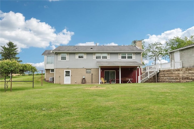 1509 Edmon Rd, Kiskiminetas Twp, PA 15618 - rear view of property with stairway, a yard, a chimney, and central AC unit