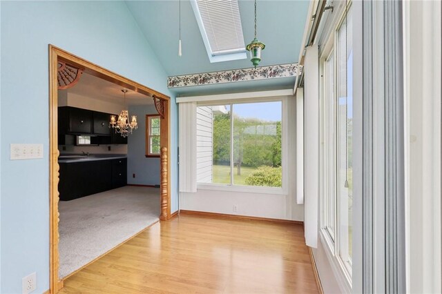 1509 Edmon Rd, Kiskiminetas Twp, PA 15618 - empty room with a chandelier, lofted ceiling, wood finished floors, a skylight, and baseboards